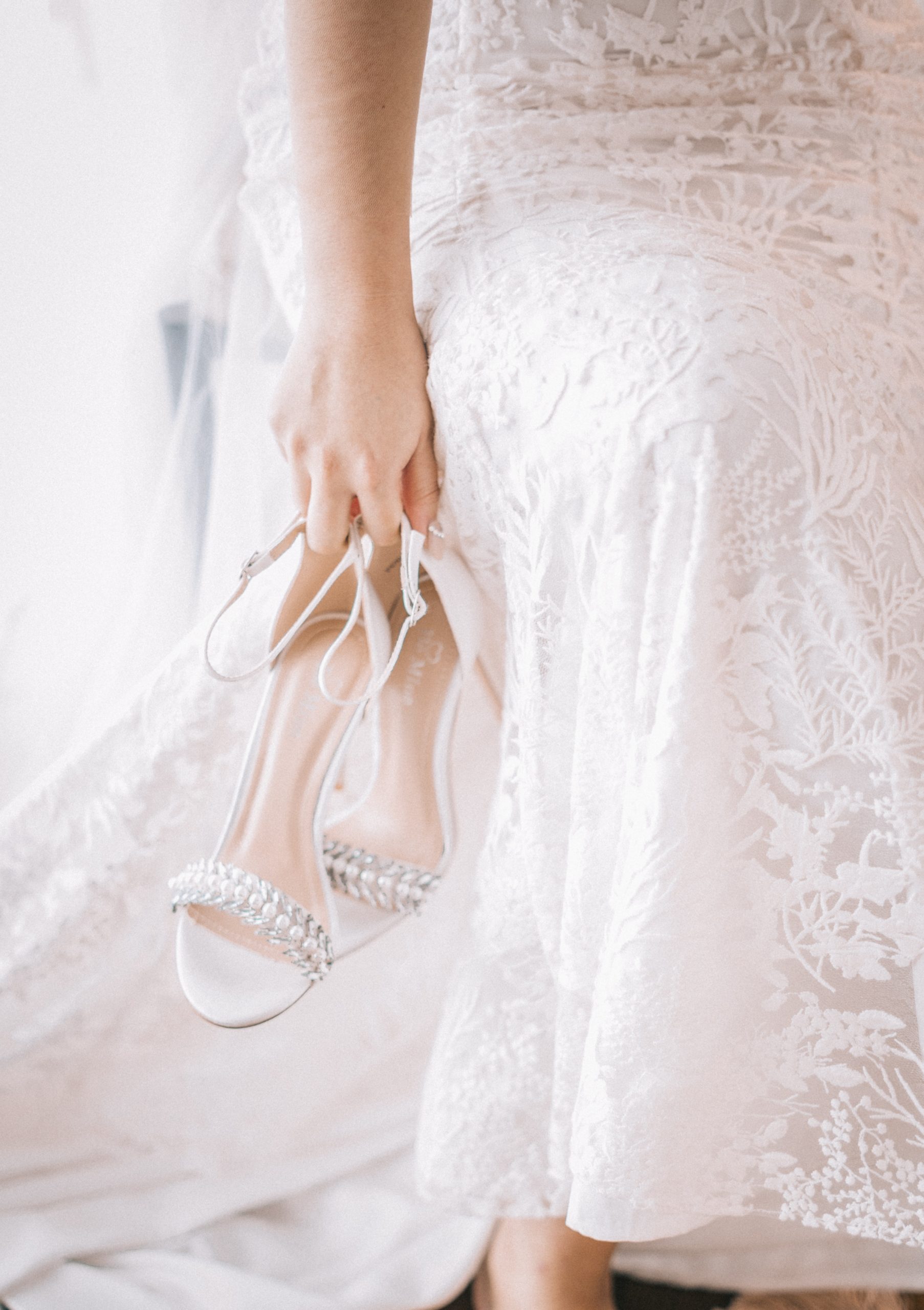 bride holding her shoes